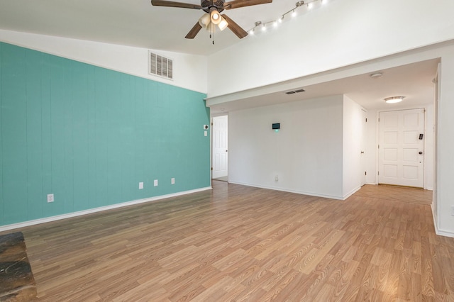 unfurnished room featuring ceiling fan, lofted ceiling, and light wood-type flooring