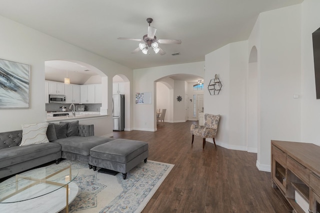 living room featuring sink, dark hardwood / wood-style floors, and ceiling fan