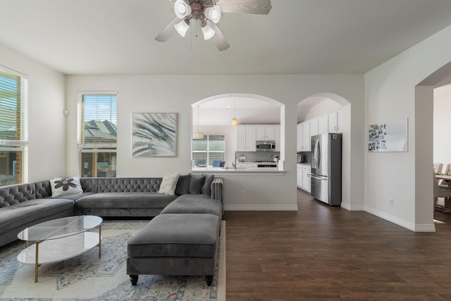 living room featuring dark wood-type flooring, sink, and ceiling fan