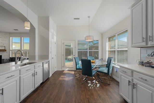 kitchen featuring white cabinetry, decorative light fixtures, and sink