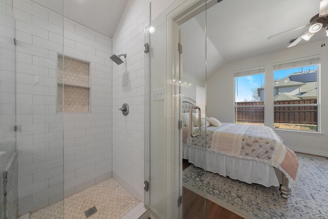 bathroom featuring a shower with door, vaulted ceiling, hardwood / wood-style floors, and ceiling fan