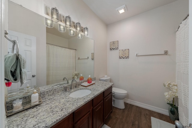 bathroom featuring vanity, toilet, and hardwood / wood-style floors