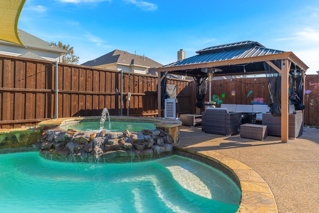 view of pool with a patio, outdoor lounge area, an in ground hot tub, pool water feature, and a gazebo