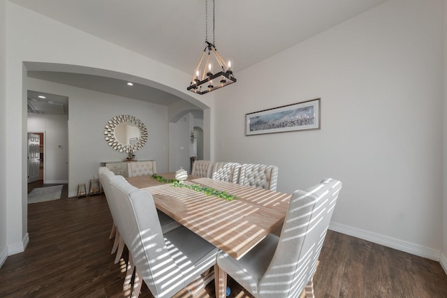 dining area featuring a notable chandelier and dark wood-type flooring