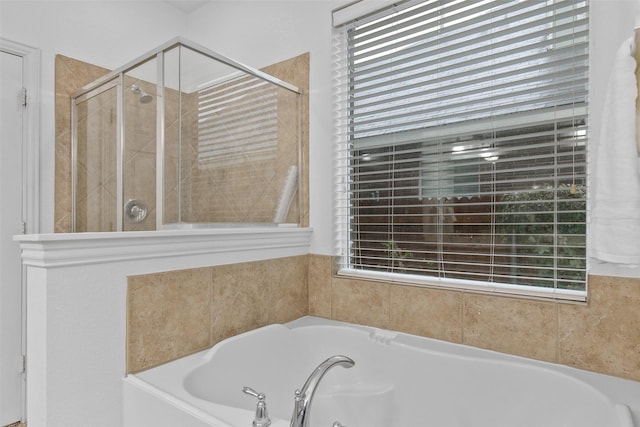 bathroom featuring separate shower and tub