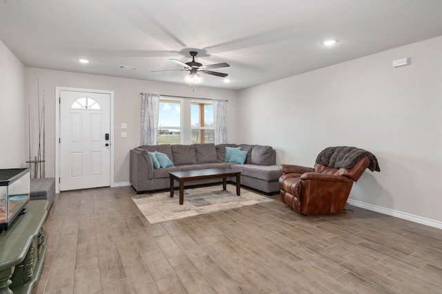 living room with visible vents, recessed lighting, light wood-style flooring, and baseboards