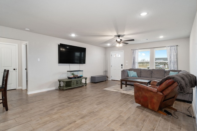 living room with ceiling fan and light hardwood / wood-style floors