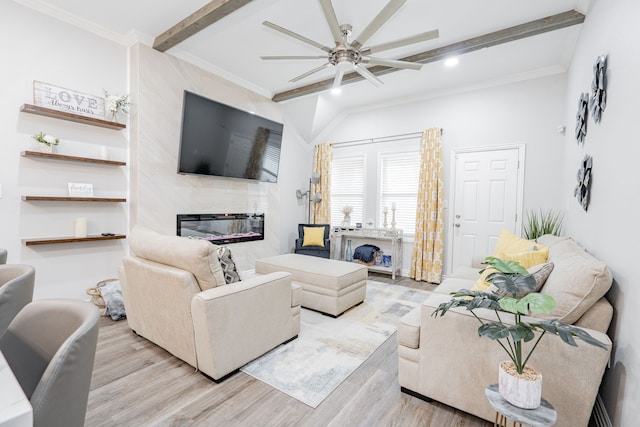 living room with crown molding, beam ceiling, a fireplace, and light hardwood / wood-style floors