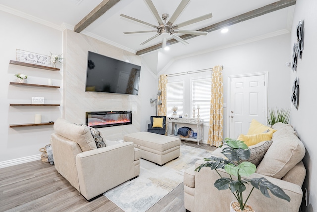 living room with crown molding, ceiling fan, a high end fireplace, beamed ceiling, and light wood-type flooring