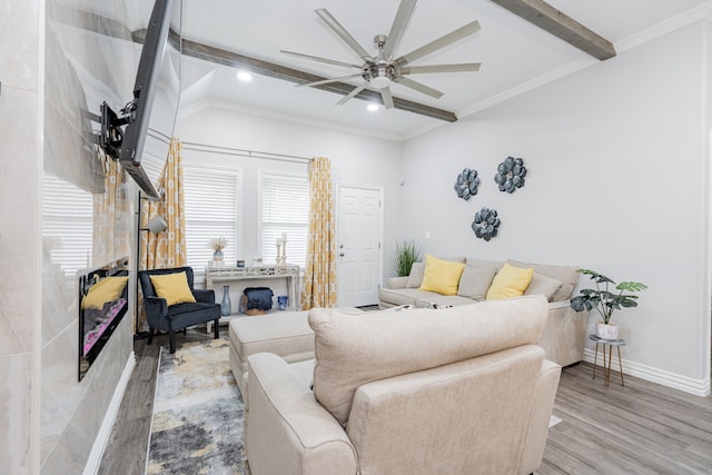 living room with lofted ceiling with beams, ceiling fan, ornamental molding, and light hardwood / wood-style floors