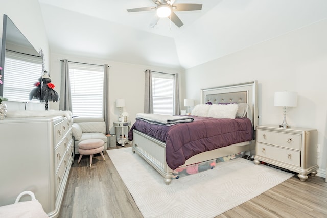 bedroom featuring lofted ceiling, ceiling fan, and light hardwood / wood-style flooring