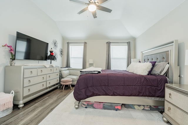 bedroom with hardwood / wood-style flooring, ceiling fan, and lofted ceiling