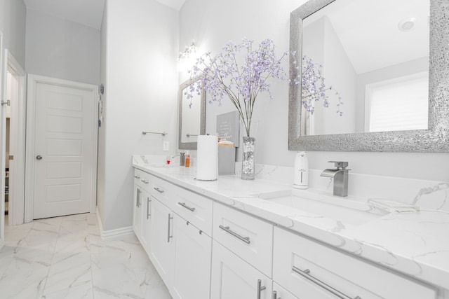 bathroom featuring lofted ceiling and vanity