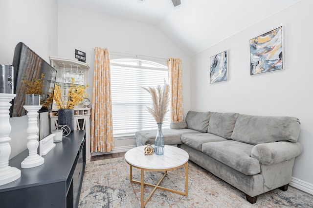 living room featuring hardwood / wood-style flooring, vaulted ceiling, and plenty of natural light