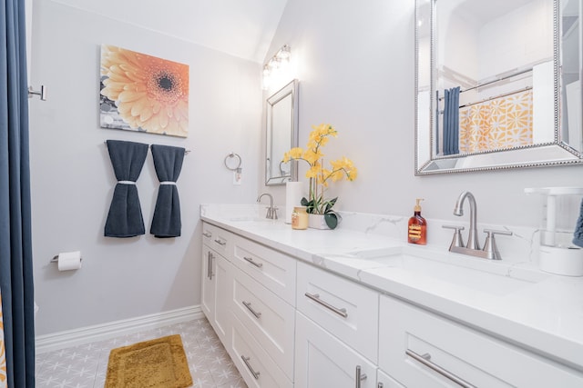 bathroom featuring vanity and vaulted ceiling