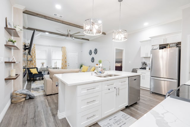 kitchen featuring appliances with stainless steel finishes, sink, hanging light fixtures, and white cabinets