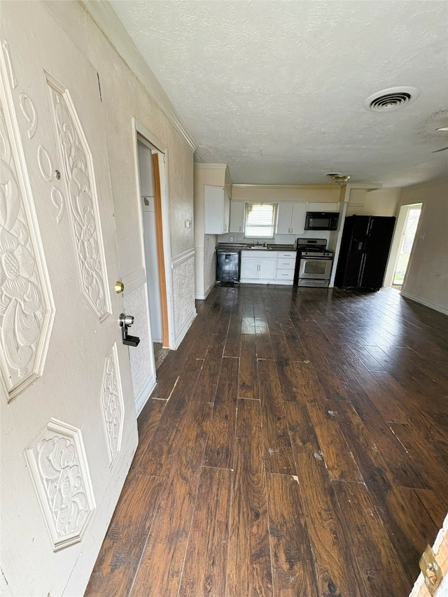 unfurnished living room featuring dark hardwood / wood-style floors and a textured ceiling