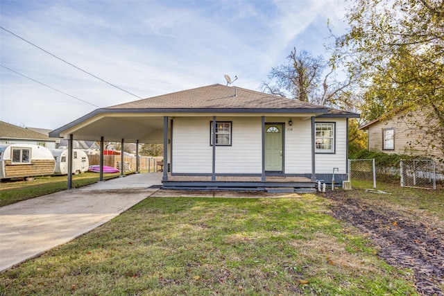 bungalow-style home with a carport and a front lawn