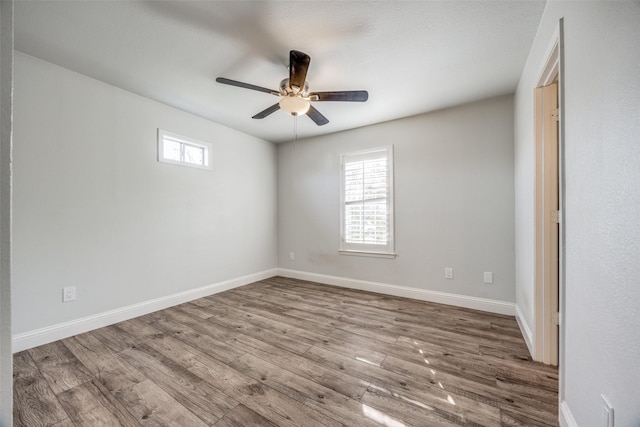 empty room with ceiling fan and wood-type flooring