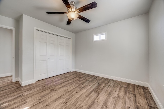 unfurnished bedroom with ceiling fan, light hardwood / wood-style floors, and a closet