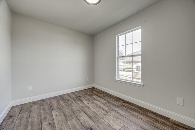 unfurnished room with light wood-type flooring