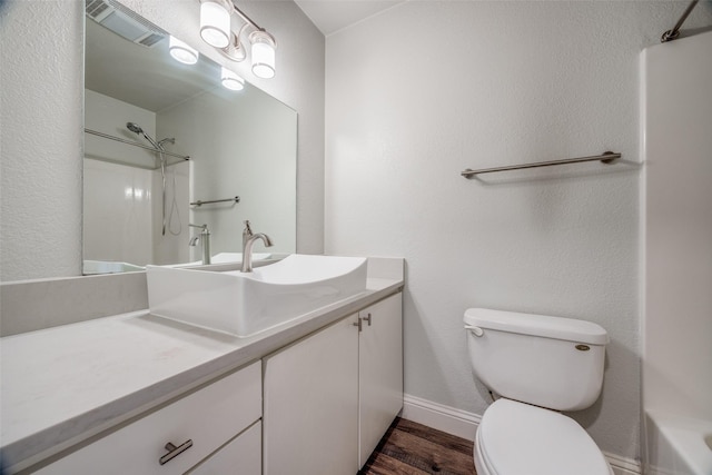 bathroom with vanity, hardwood / wood-style flooring, and toilet