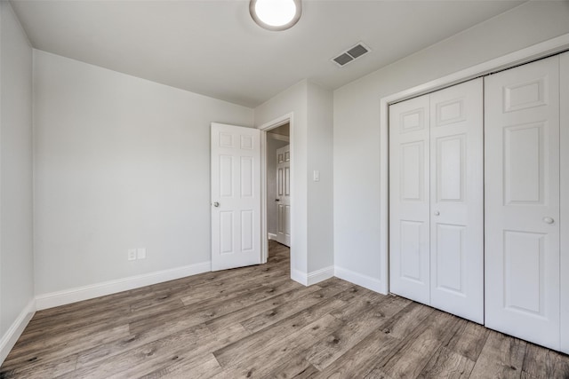 unfurnished bedroom featuring a closet and light hardwood / wood-style flooring