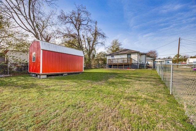 view of yard with a wooden deck and a shed