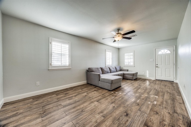 unfurnished living room featuring ceiling fan and hardwood / wood-style floors