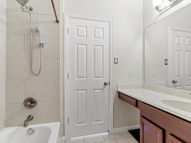 bathroom with tiled shower / bath, vanity, and tile patterned floors