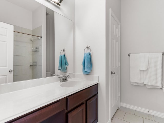 bathroom featuring vanity, a tile shower, and tile patterned floors