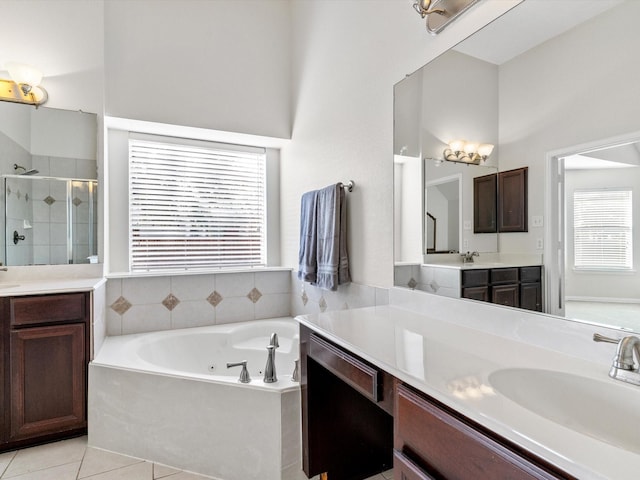 bathroom with independent shower and bath, vanity, and tile patterned floors