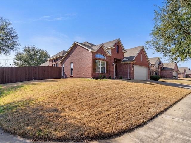 view of property featuring a garage and a front lawn