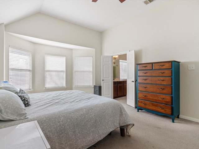 carpeted bedroom featuring ensuite bathroom, lofted ceiling, and ceiling fan