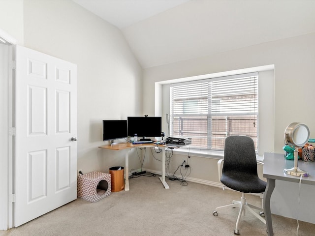 carpeted office space with vaulted ceiling