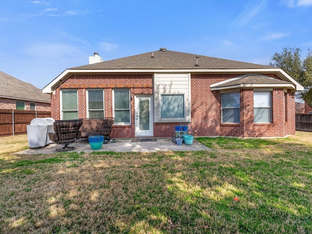 rear view of house with a yard and a patio