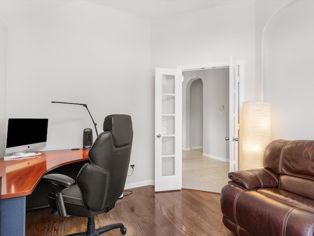 home office featuring hardwood / wood-style flooring and french doors