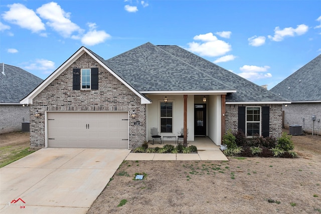 view of front of home featuring cooling unit and a garage