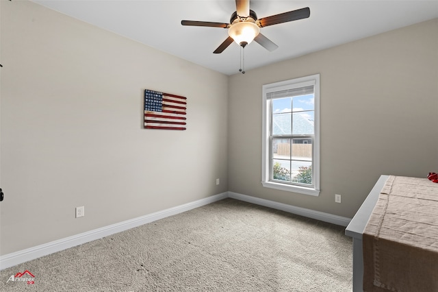 spare room featuring ceiling fan and carpet flooring