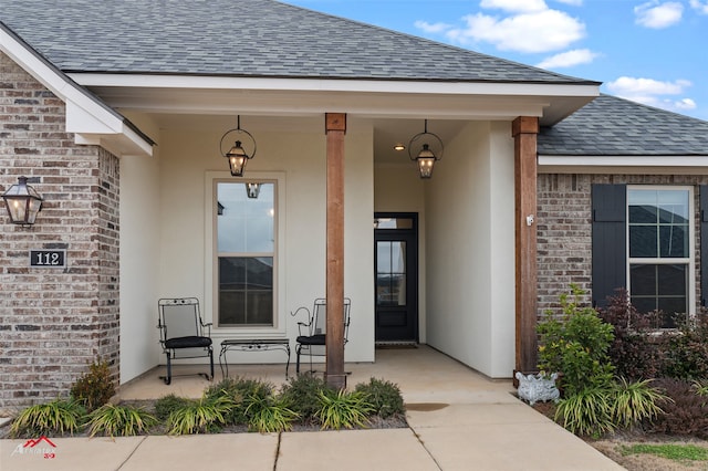 view of exterior entry featuring covered porch