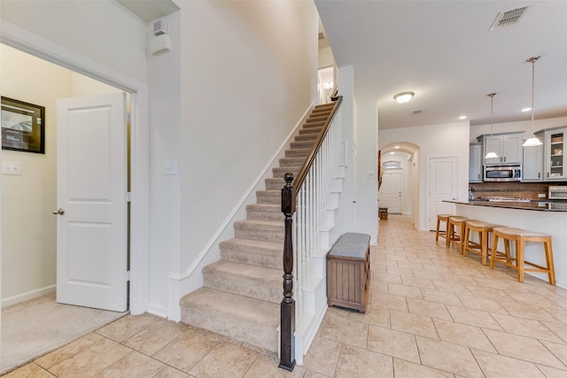 stairway featuring tile patterned flooring