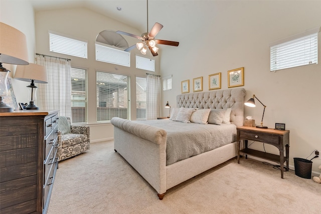 carpeted bedroom with high vaulted ceiling and ceiling fan