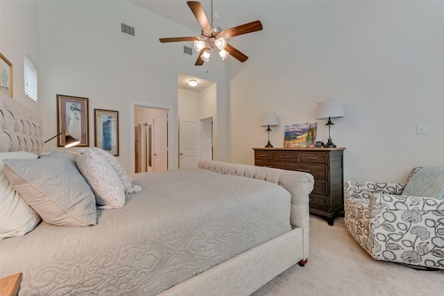 bedroom featuring light carpet, a towering ceiling, and ceiling fan