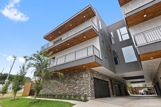 4330 Dickason Ave Unit 201, Dallas, TX 75219 - view of property featuring a garage and concrete driveway
