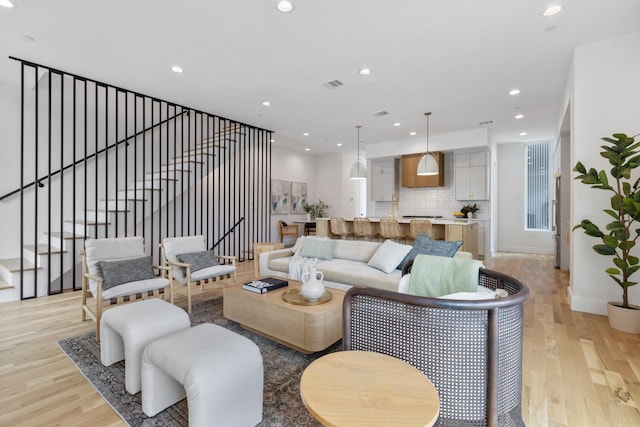 4330 Dickason Ave Unit 201, Dallas, TX 75219 - living room featuring light wood-type flooring, recessed lighting, stairs, and baseboards