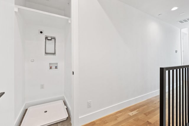 4330 Dickason Ave Unit 201, Dallas, TX 75219 - clothes washing area with hookup for an electric dryer, light wood-style floors, washer hookup, baseboards, and hookup for a gas dryer