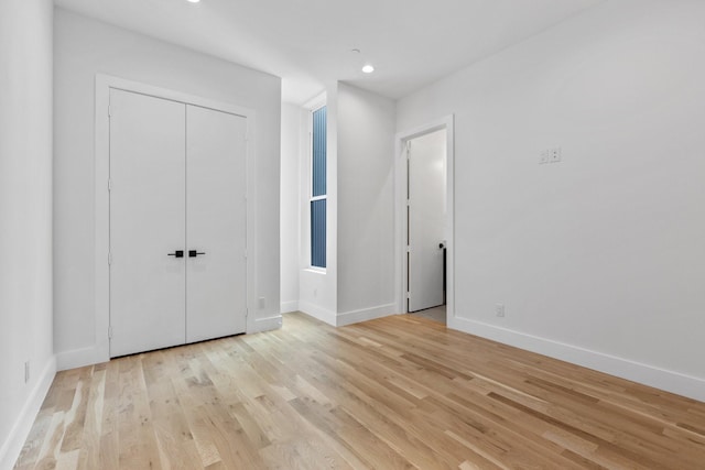 4330 Dickason Ave Unit 201, Dallas, TX 75219 - unfurnished bedroom with light wood-style flooring, baseboards, a closet, and recessed lighting