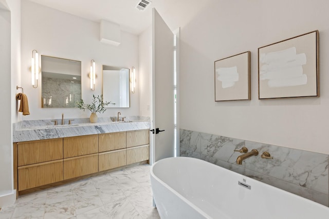 4330 Dickason Ave Unit 201, Dallas, TX 75219 - bathroom featuring double vanity, marble look tiles, a soaking tub, and a shower