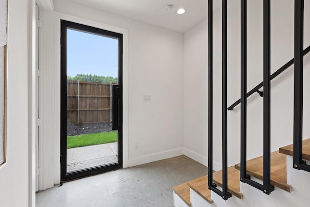 4330 Dickason Ave Unit 201, Dallas, TX 75219 - entryway with finished concrete flooring, stairs, and baseboards