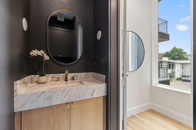4330 Dickason Ave Unit 201, Dallas, TX 75219 - bathroom with wood finished floors, baseboards, and vanity
